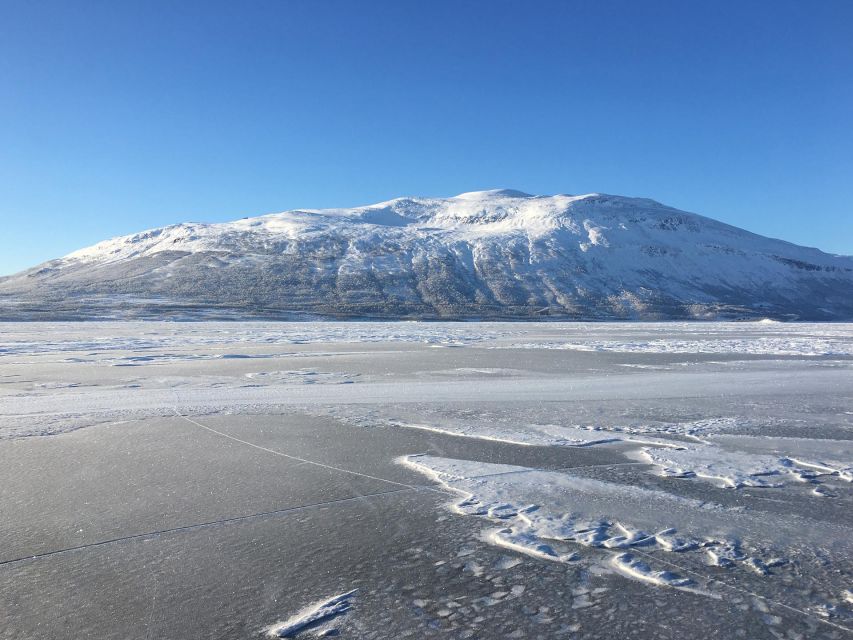 Abisko: Lake Torneträsk Arctic Ice Fishing Trip - Sitting above a frozen Arctic lake